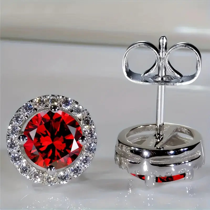 Luisa – Orecchini in rubino con motivo a sole.